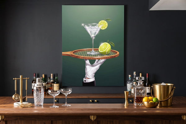 Basement bar ideas: a Drinks Are Now Served canvas above a home bar with a cocktail shaker and coupe glasses