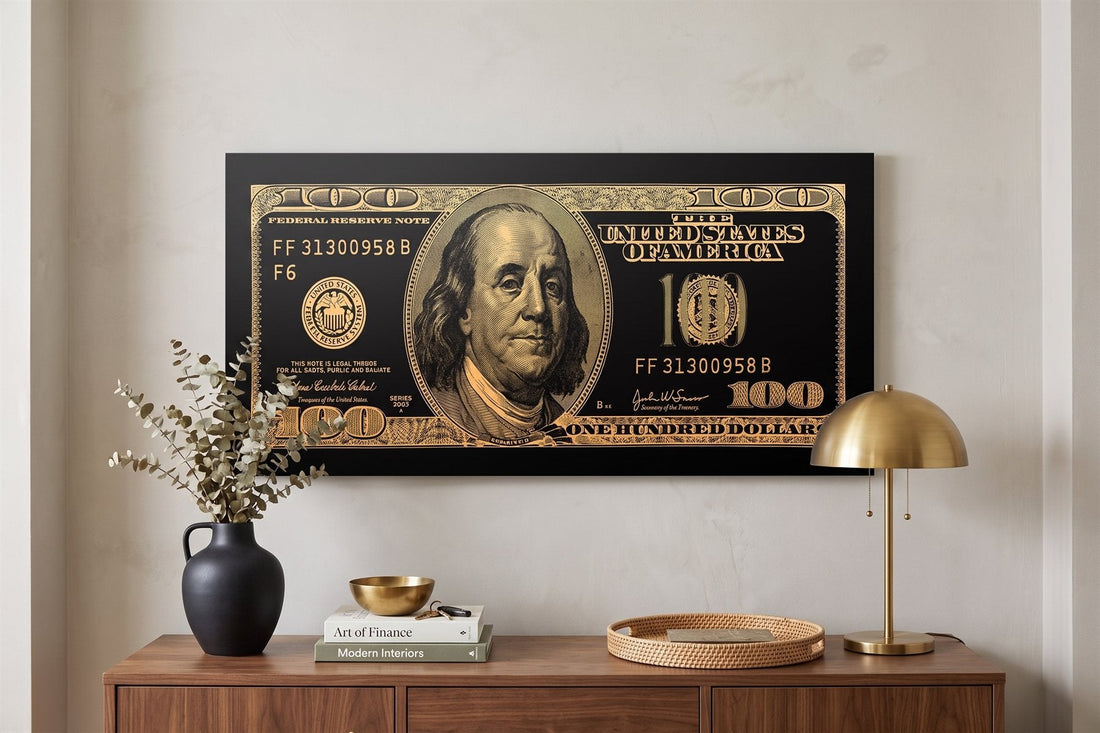 Entryway wall art: a gold hundred-dollar canvas above a console with eucalyptus, books and a brass lamp