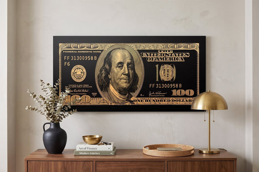 Entryway wall art: a gold hundred-dollar canvas above a console with eucalyptus, books and a brass lamp