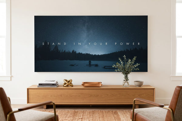Famous black and white photography: a Stand In Your Power canvas above an oak console with photo books