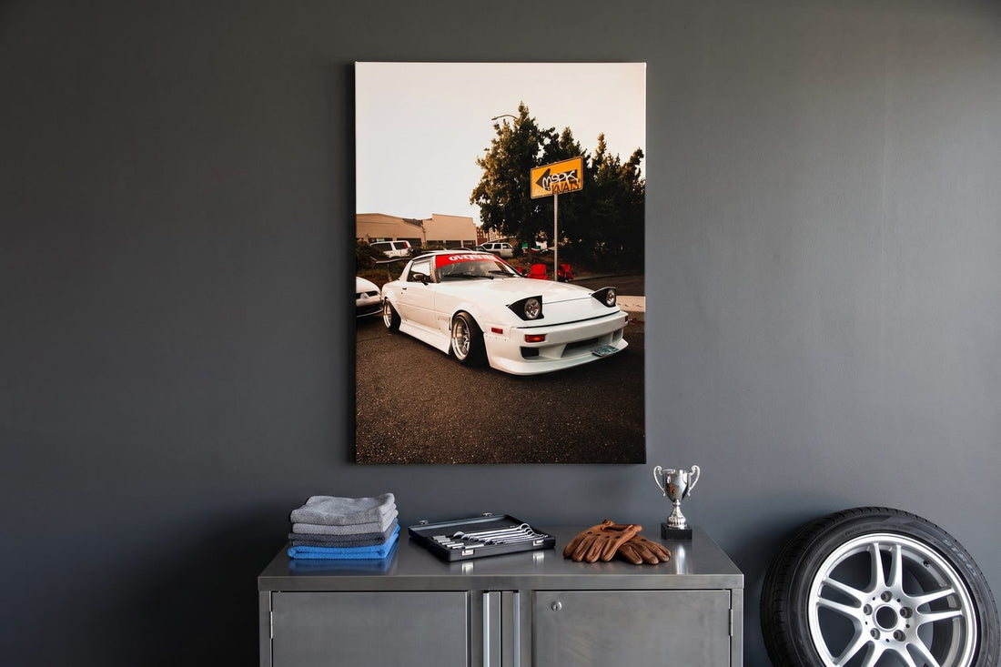 Garage decor ideas: a Retro Rebellion canvas above a steel cabinet with a tool roll, driving gloves and an alloy wheel