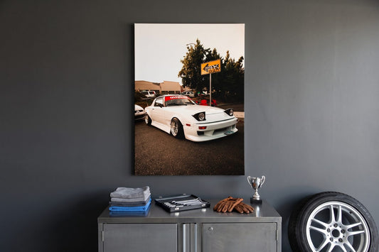 Garage decor ideas: a Retro Rebellion canvas above a steel cabinet with a tool roll, driving gloves and an alloy wheel