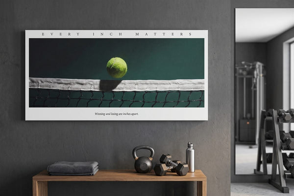 Garage gym ideas: Every Inch Matters tennis canvas on a concrete gym wall above a kettlebell and dumbbells