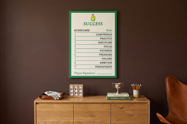 Golf handicap explained: a Success Scorecard canvas in a brown study with a golf glove, balls and a trophy cup