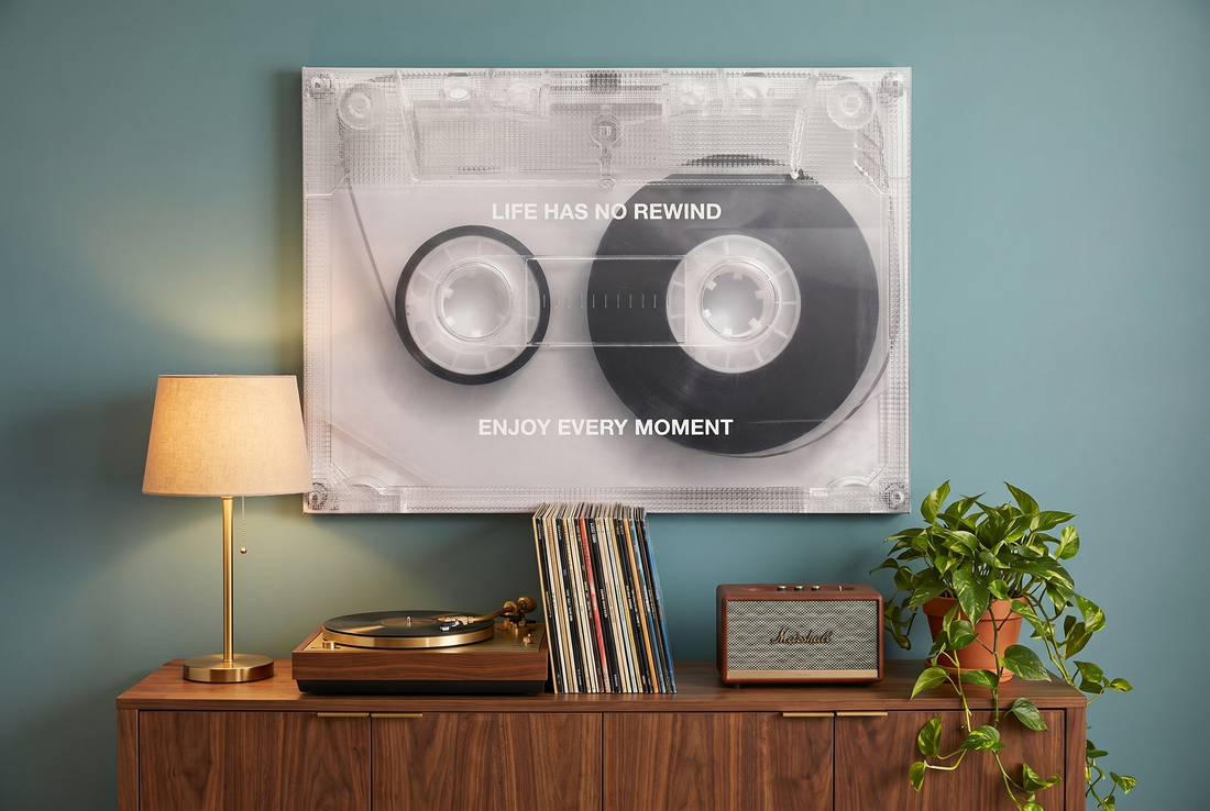 Music wall art: a No Rewind cassette canvas above a credenza with a turntable and vinyl records