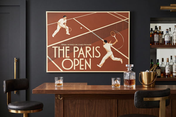 Man cave bar ideas: The Paris Open canvas above a home bar with a whisky decanter and ice bucket