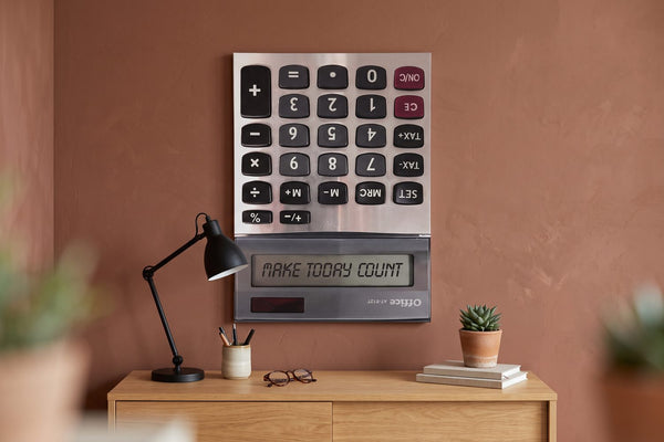 Motivational quotes for the office: a Make Today Count canvas above a walnut desk with a task lamp and leather notebook