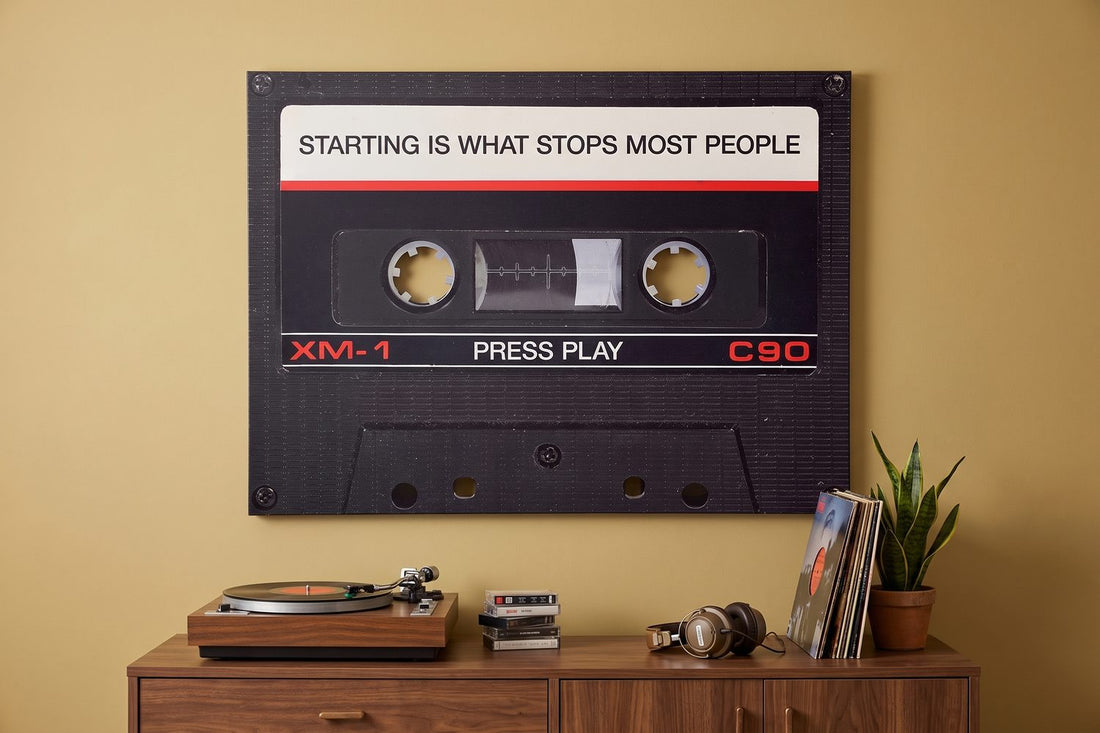 Music quotes: a Press Play cassette canvas in a mustard retro living room with a turntable and vinyl records