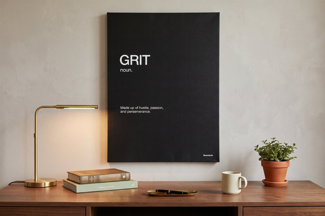 Quote wall art: a Grit definition canvas in a warm study with a brass lamp, books and a fountain pen