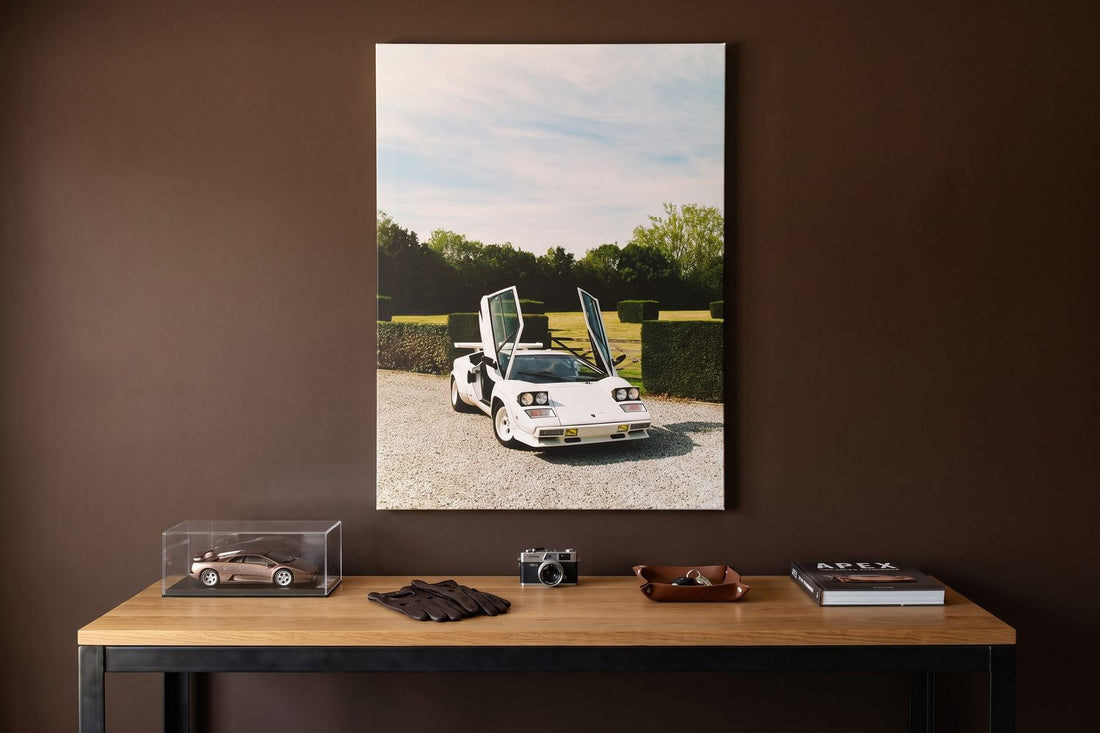 What makes a car a supercar: a Bull Legacy canvas in a garage office with a model car and driving gloves