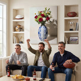 Three friends cheering on game day on a sofa under the American Football Vase canvas