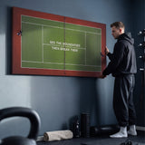 Person admiring the Break Boundaries Match tennis canvas print in a styled interior