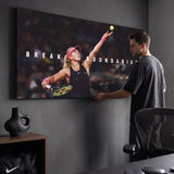 Person admiring the Break Boundaries tennis canvas print in a styled interior