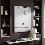 Car Boarding canvas above a white console in a dark brown living room with ski goggles and Alpine books