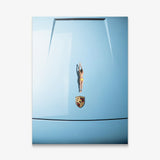 Car Dive canvas wall art of a diver in a yellow swimsuit poised on a pale blue sports car hood seen from above