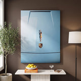 Car Dive canvas on a mocha wall above a stone console with a bowl of lemons, an olive tree and a floor lamp
