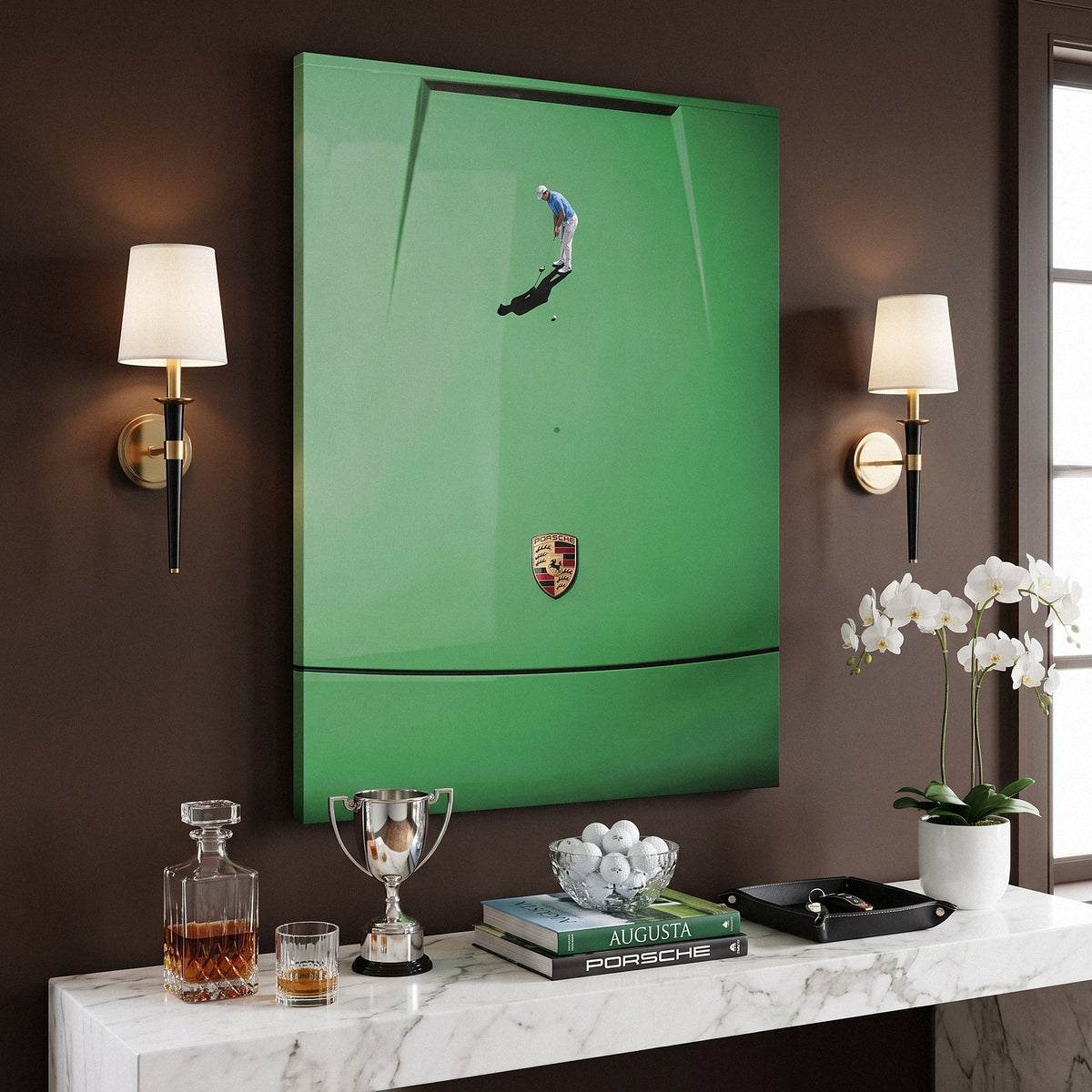 Car Putt canvas in a chocolate brown study above a console with a golf trophy, golf books and white orchids