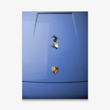 Car Surfing canvas wall art of a surfer riding a small board across a royal blue sports car hood seen from above