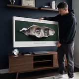 Man hanging the Chase The Vision Franklin canvas in a navy living room