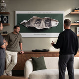 Chase The Vision Franklin wall art in a lounge with three men talking