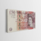 A rectangular canvas wall art print featuring a stylized, blurred depiction of a British £50 banknote with the text 'CHASE THE VISION, NOT THE MONEY.' printed across the center, shown hanging on a light gray wall.