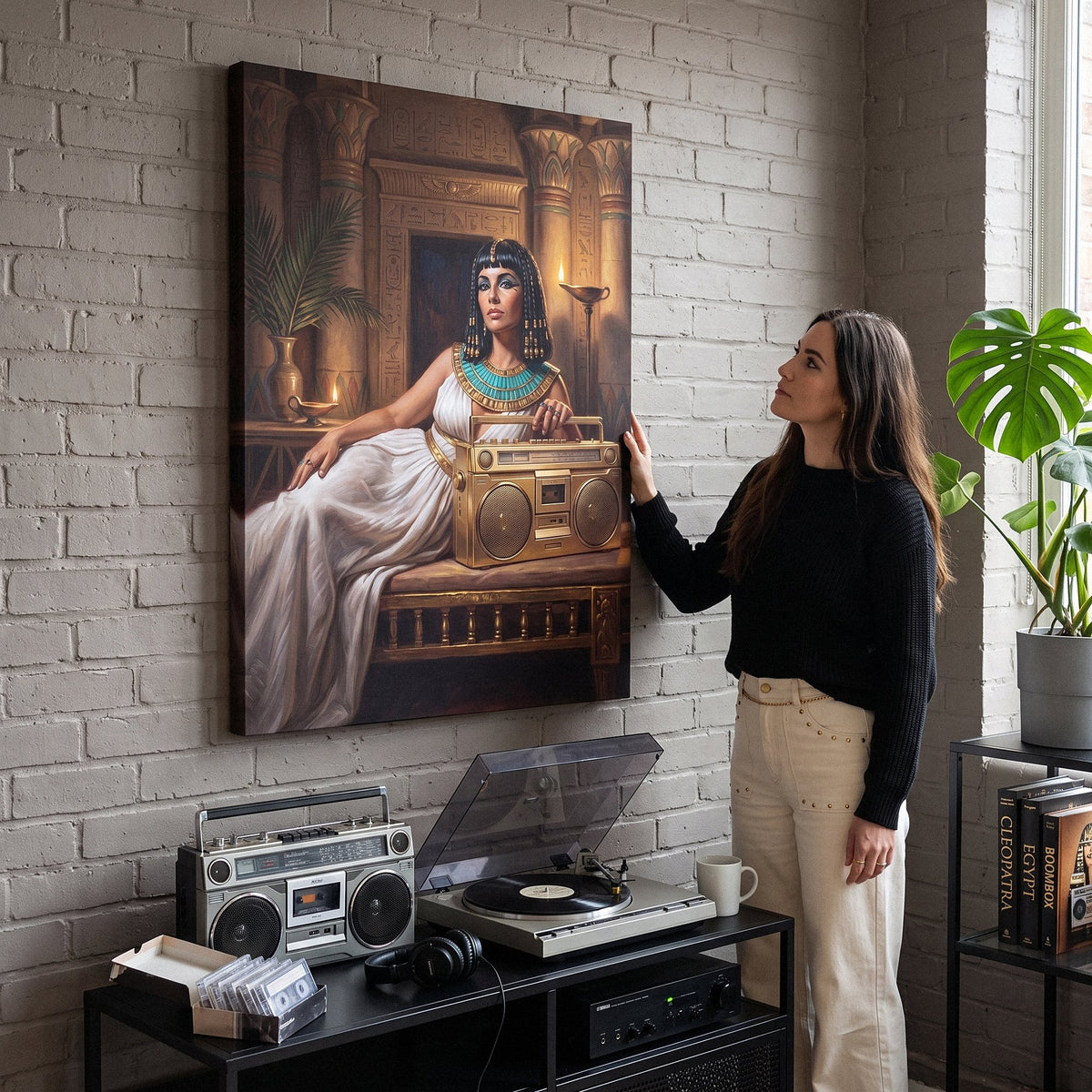 Cleopatra On Blast canvas above a desk with a person looking at it