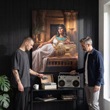 Cleopatra On Blast canvas in a living room with two people