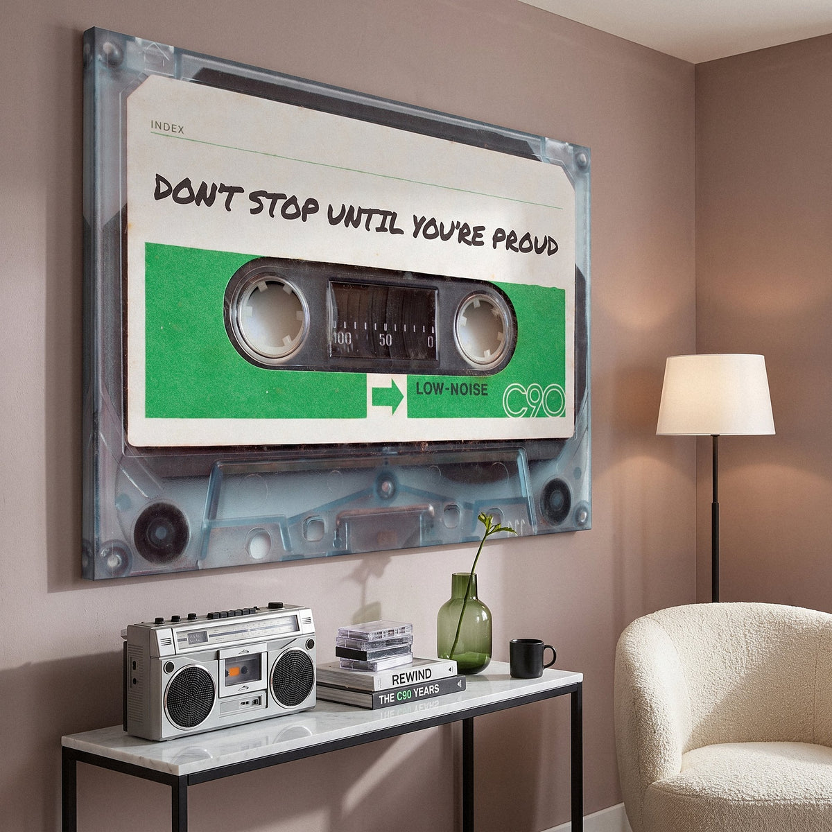 Don't Stop Until You Are Proud cassette canvas above a marble console with a boombox in a rose taupe reading corner