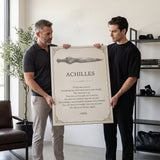 Two men carrying the Doomed Achilles quote canvas into a bone-white living room