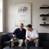 Coach and athlete reviewing a training plan on a sofa below the Endure lion quote canvas