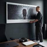 Endure The Arena lion wall art with a man in a dark home office