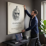 Man hanging the Eternity gladiator quote canvas above his desk in a home office