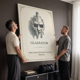 Two men holding the Eternity gladiator quote canvas against a living room wall