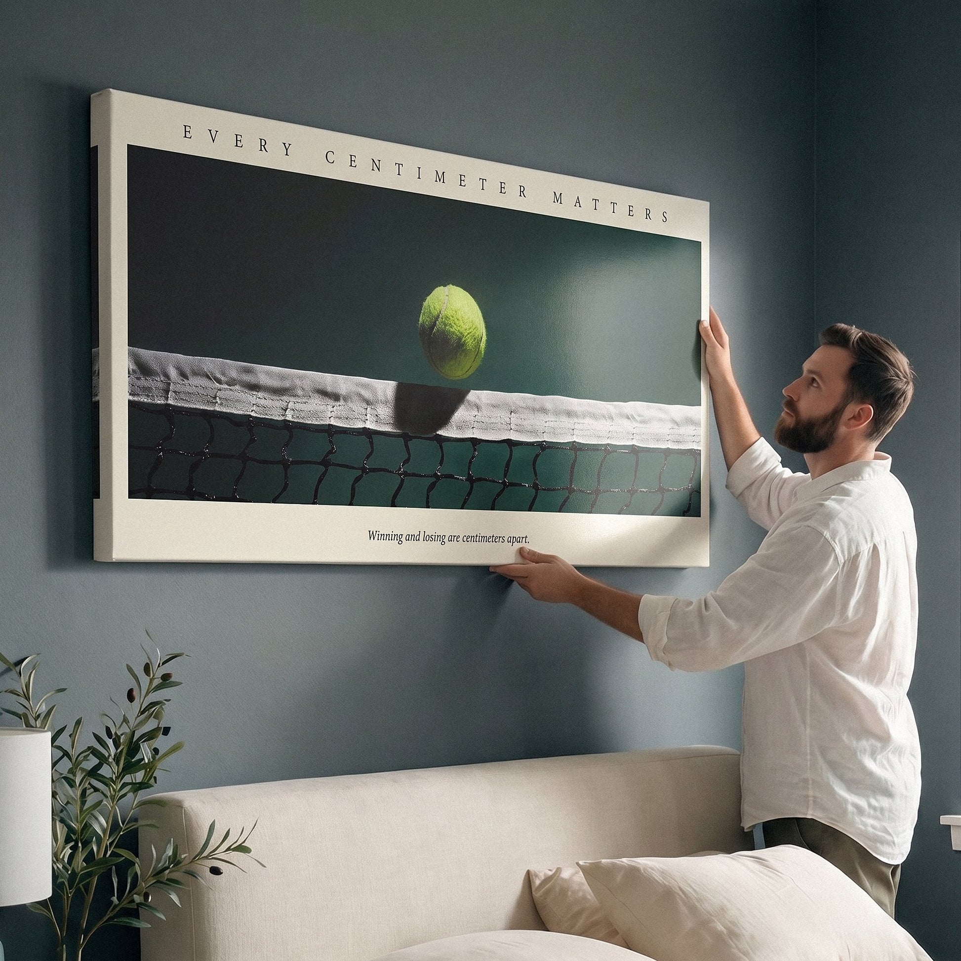 Person holding the Every Centimeter Matters tennis panoramic canvas print against a wall