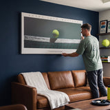 Person admiring the Every Inch Matters tennis canvas print in a styled interior