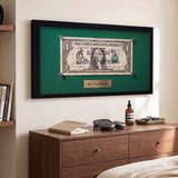 First Dollar canvas print above a bedroom dresser, angled view showing the gallery wrap edge