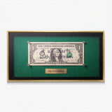 First Dollar canvas in a gold floating frame