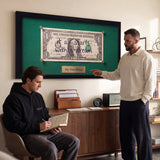 First Dollar wall art in a study with two men working
