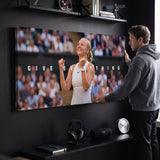 Person admiring the Give Everything tennis canvas print in a styled interior