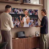 Two people viewing the Give Everything tennis canvas print together in a home setting