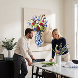 Couple arranging tulips at a dining table under the Golf Vase canvas