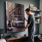 Man hanging It All Starts With A Dream E30 coupe canvas wall art in a study