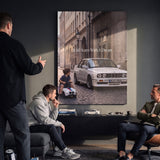 Couple hanging It All Starts With A Dream E30 coupe canvas wall art in a lounge
