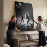 Two people viewing the It All Starts With A Dream tennis canvas print together in a home setting