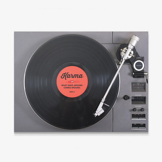 Karma canvas wall art, turntable with a black vinyl record and a coral label reading What Goes Around Comes Around