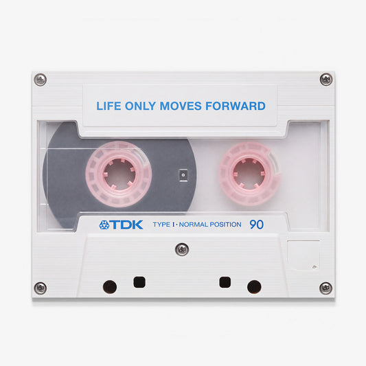 Life Only Moves Forward canvas wall art, a white cassette tape with pink spools and the line printed in blue on the label