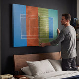 Person holding the Majors Courts tennis canvas print against a wall