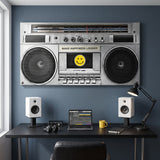 Wide Make Happiness Louder boombox canvas above a studio desk with two white monitors on a slate blue wall