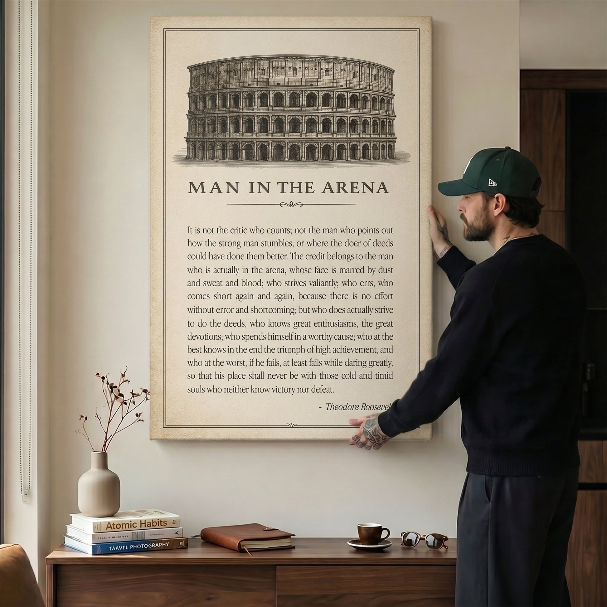 Man hanging the Man In The Arena Colosseum quote canvas above a credenza