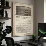Man In The Arena Colosseum quote canvas above a modern dark desk